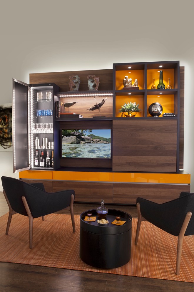 This is an example of a large modern open plan living room in New York with a home bar, grey walls, dark hardwood flooring, no fireplace and a built-in media unit.