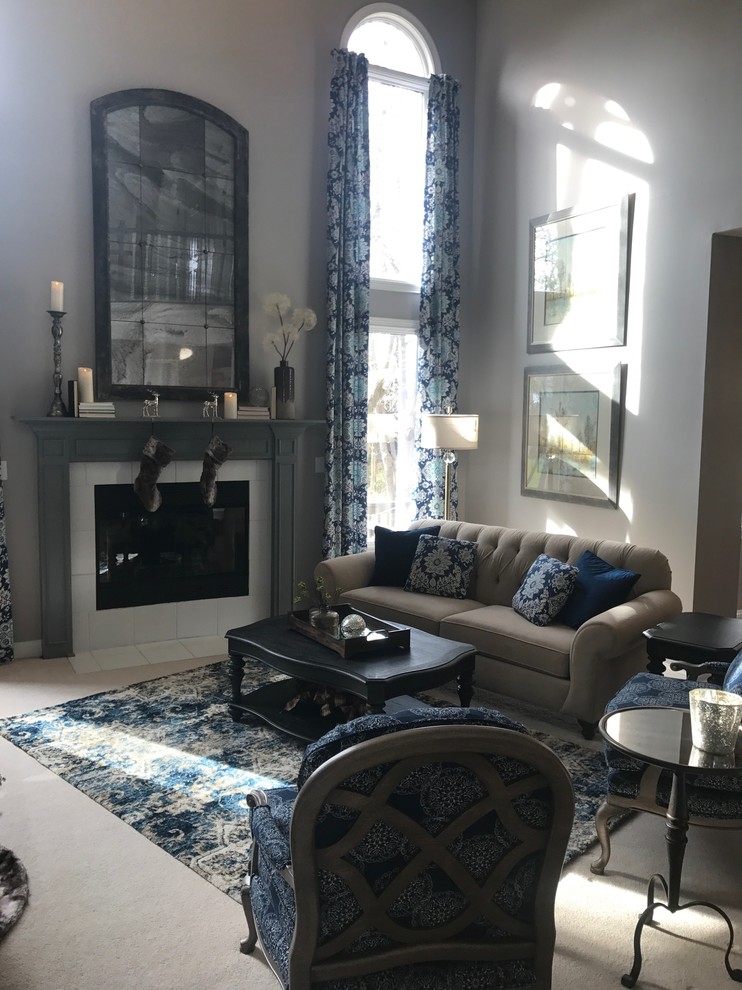This is an example of a medium sized traditional enclosed living room in Indianapolis with beige walls, carpet, a standard fireplace, a tiled fireplace surround, a wall mounted tv and beige floors.