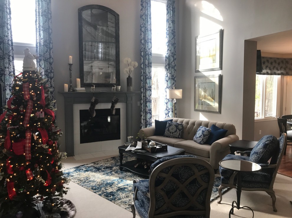 Photo of a medium sized traditional enclosed living room in Indianapolis with beige walls, carpet, a standard fireplace, a tiled fireplace surround, a wall mounted tv and beige floors.