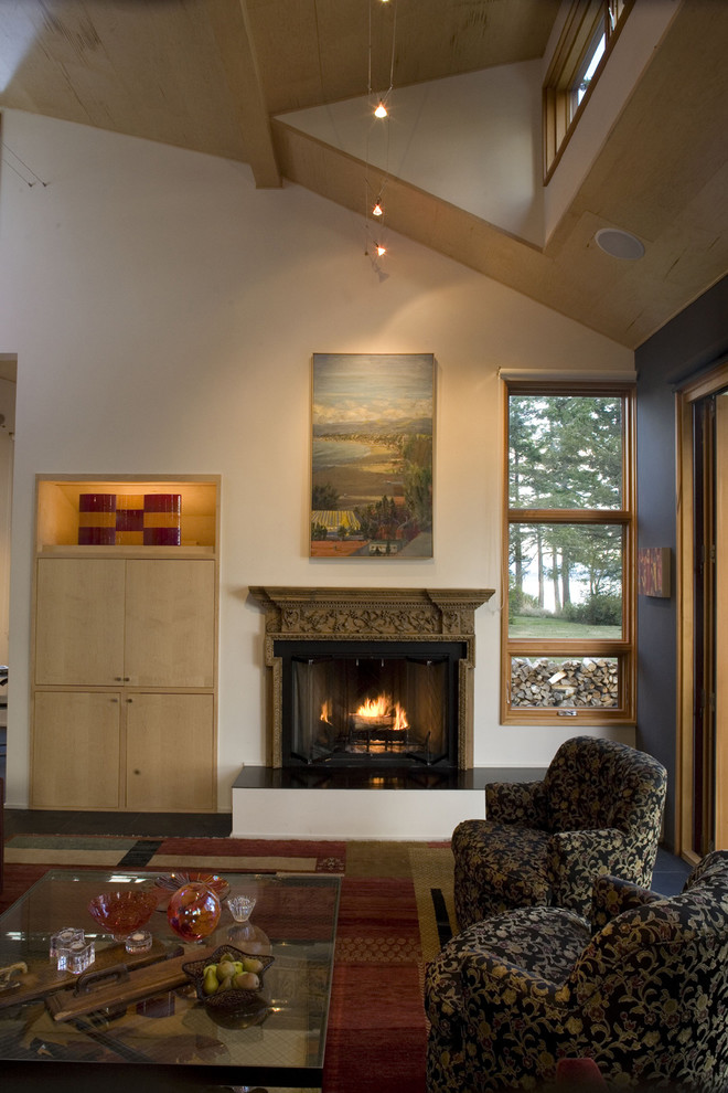 This is an example of an eclectic living room in Seattle with a standard fireplace.