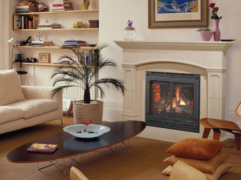 Photo of a medium sized coastal enclosed living room in New York with beige walls, carpet, a standard fireplace and a plastered fireplace surround.
