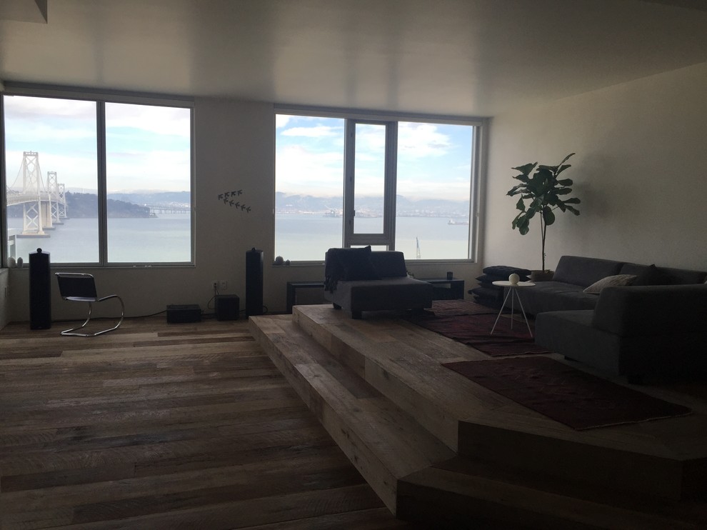 Large minimalist open concept medium tone wood floor living room photo in San Francisco with white walls