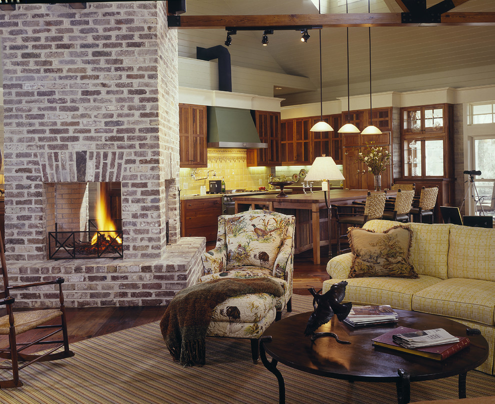 Inspiration for a medium sized rural open plan living room in Atlanta with a two-sided fireplace, white walls, dark hardwood flooring and a brick fireplace surround.