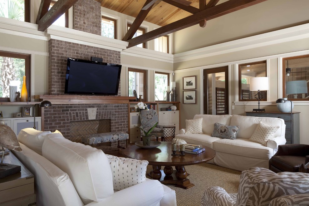 Inspiration for a large contemporary medium tone wood floor living room remodel in Atlanta with beige walls, a wall-mounted tv and a brick fireplace