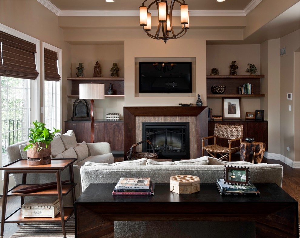 Photo of a medium sized contemporary open plan living room in Chicago with beige walls, dark hardwood flooring, a standard fireplace, a tiled fireplace surround, a built-in media unit and brown floors.