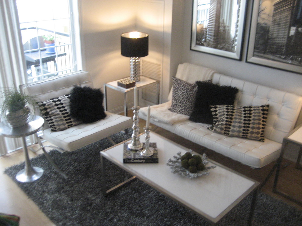 Foto di un piccolo soggiorno minimal aperto con pareti bianche, parquet chiaro, TV autoportante, nessun camino e pavimento beige