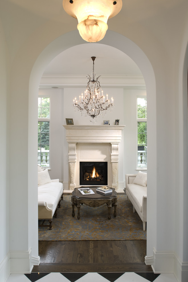 Inspiration for a mediterranean living room in Minneapolis with a stone fireplace surround and white walls.