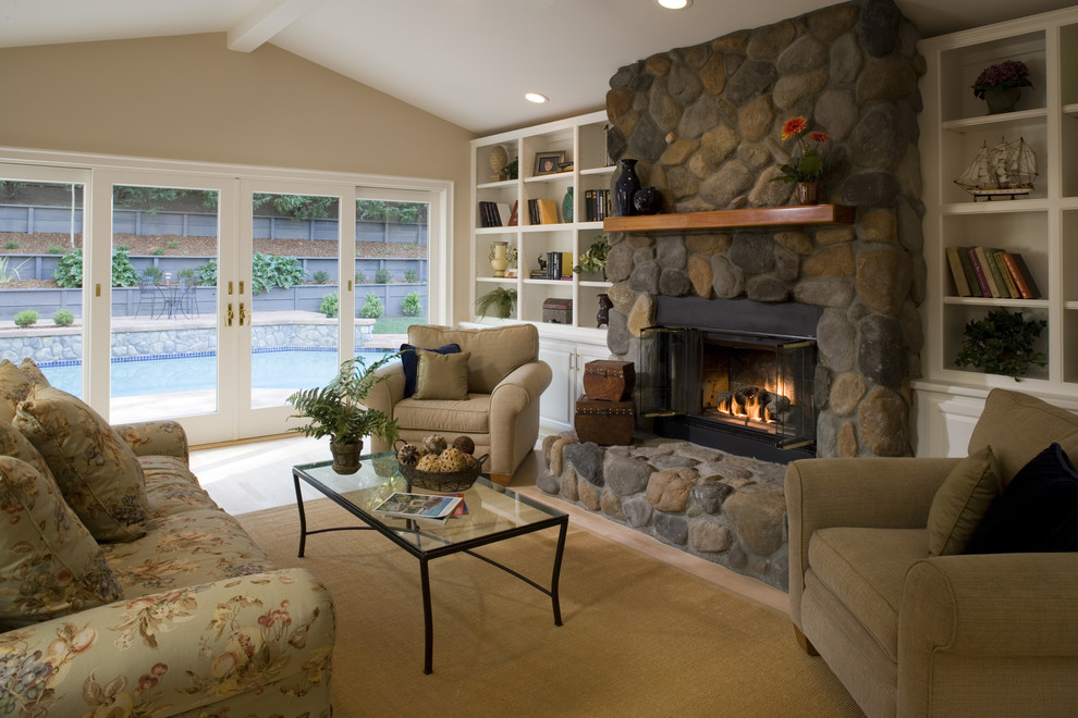 Living room - traditional living room idea in San Francisco with a standard fireplace and a stone fireplace