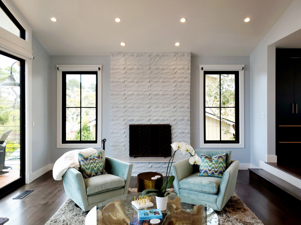 Inspiration for a large country formal and open concept dark wood floor and brown floor living room remodel in Other with blue walls, a standard fireplace, a tile fireplace and a wall-mounted tv