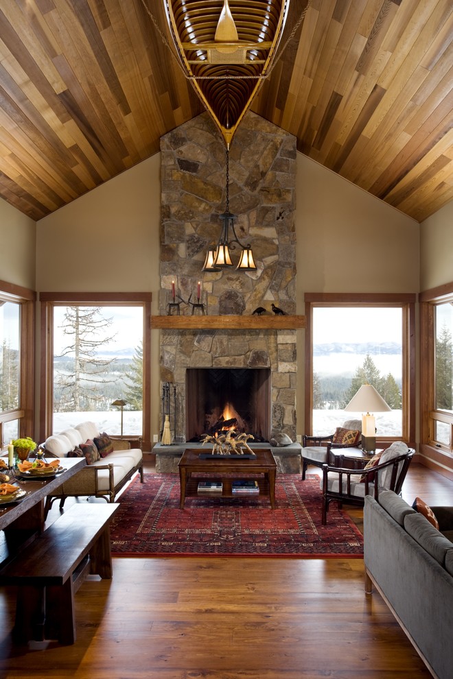 Mountain style living room photo in Boise with a stone fireplace