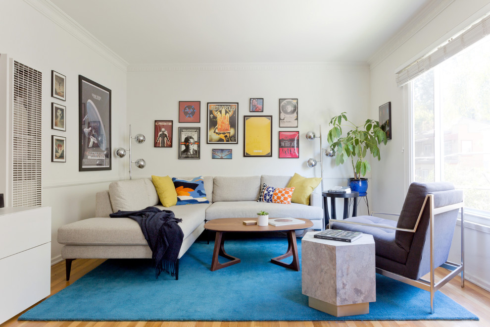 Esempio di un soggiorno moderno di medie dimensioni e aperto con pareti bianche, parquet chiaro, nessun camino, TV a parete e pavimento beige