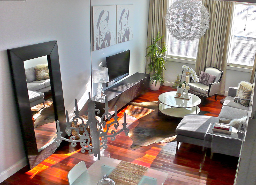 Example of a small minimalist living room design in New York with white walls and a wall-mounted tv