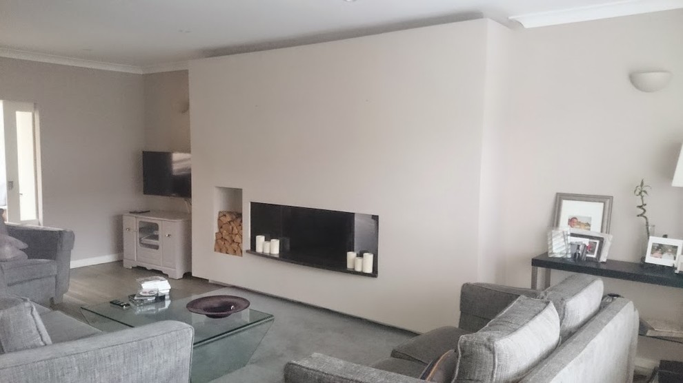 Design ideas for a large modern enclosed living room in Dublin with a music area, grey walls, medium hardwood flooring, a wood burning stove, a plastered fireplace surround and a wall mounted tv.