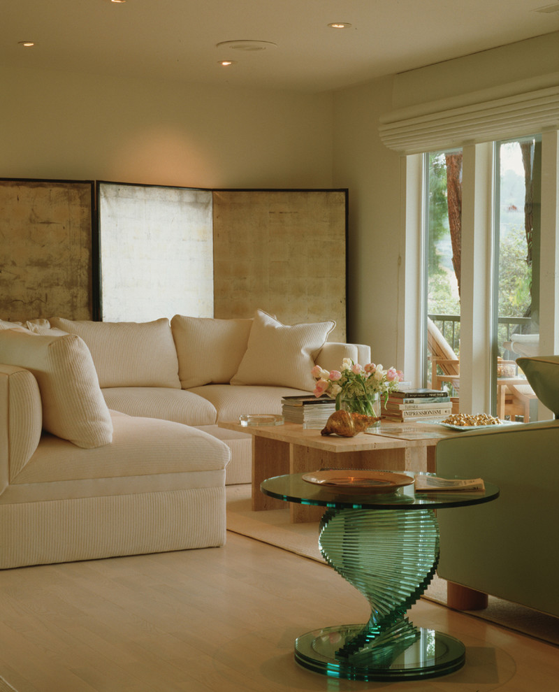 Foto di un piccolo soggiorno design con pareti beige, parquet chiaro, camino classico e cornice del camino in pietra