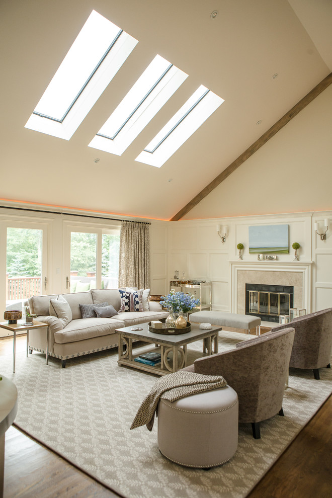 Large classic formal enclosed living room in New York with a standard fireplace, beige walls, dark hardwood flooring, a stone fireplace surround, no tv and brown floors.