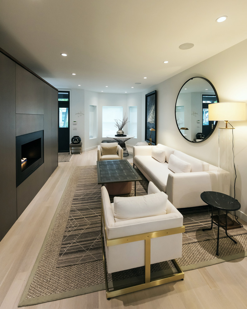 Example of a large minimalist open concept light wood floor and white floor living room design in Chicago with white walls, a ribbon fireplace and a wood fireplace surround