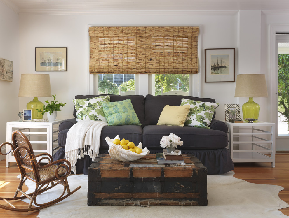 Example of a beach style medium tone wood floor living room design in Providence with white walls