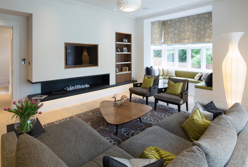 Living room - contemporary formal light wood floor living room idea in London with white walls, a ribbon fireplace and a wall-mounted tv