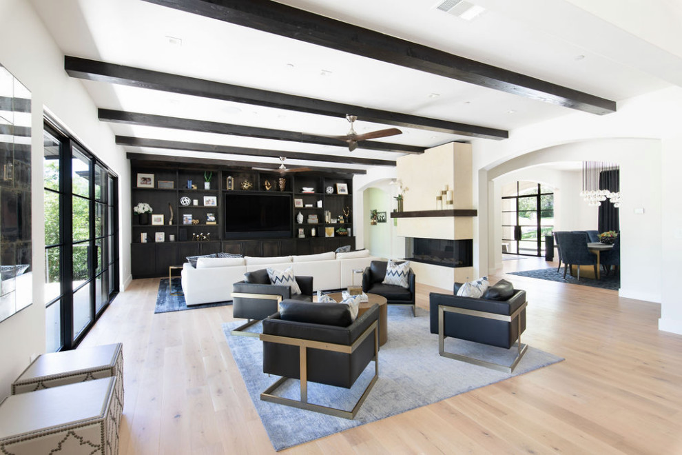 Inspiration for a large traditional open plan living room in Austin with white walls, light hardwood flooring, a ribbon fireplace, a stone fireplace surround, a built-in media unit and exposed beams.