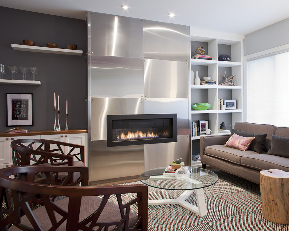 This is an example of a contemporary living room in Toronto with black walls and a ribbon fireplace.