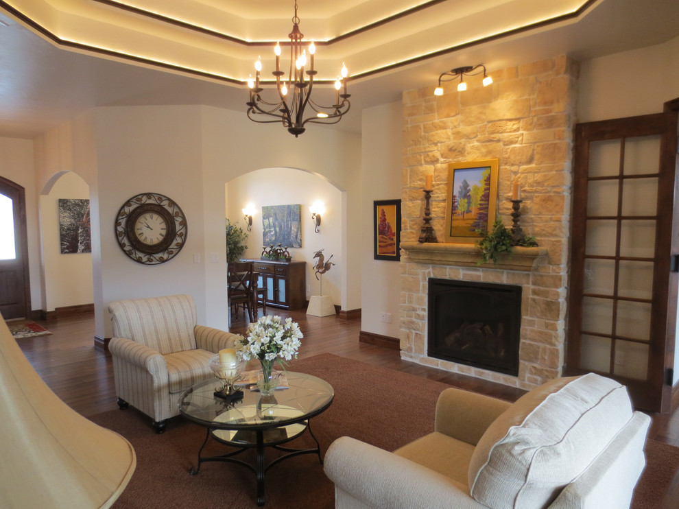 Large traditional mezzanine living room in Denver with white walls, dark hardwood flooring, a standard fireplace, a stone fireplace surround and no tv.