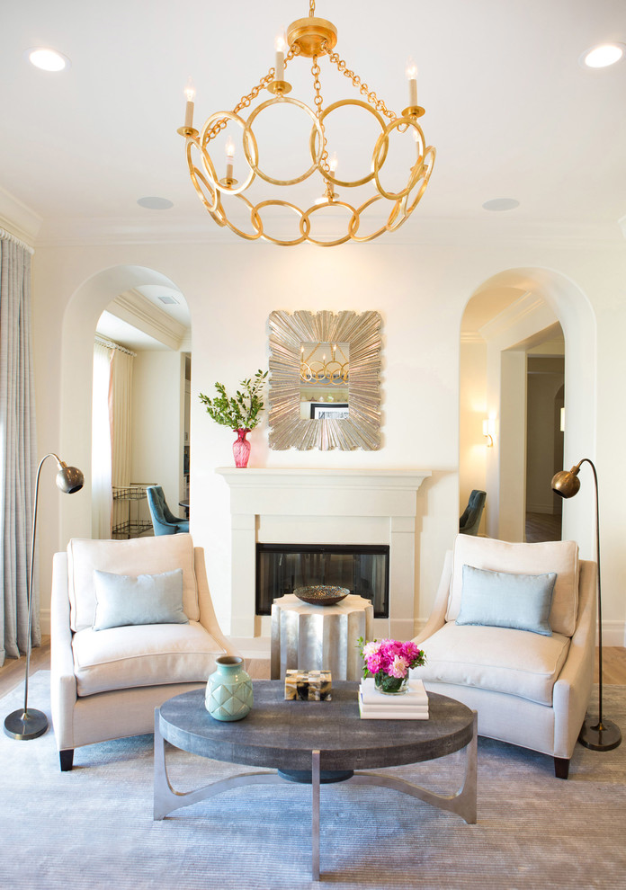 Inspiration for a large transitional formal and enclosed medium tone wood floor living room remodel in San Diego with white walls, a standard fireplace and a stone fireplace