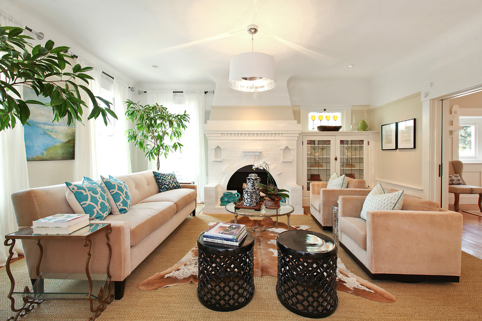 Example of a trendy living room design in San Francisco with beige walls, a standard fireplace and a brick fireplace