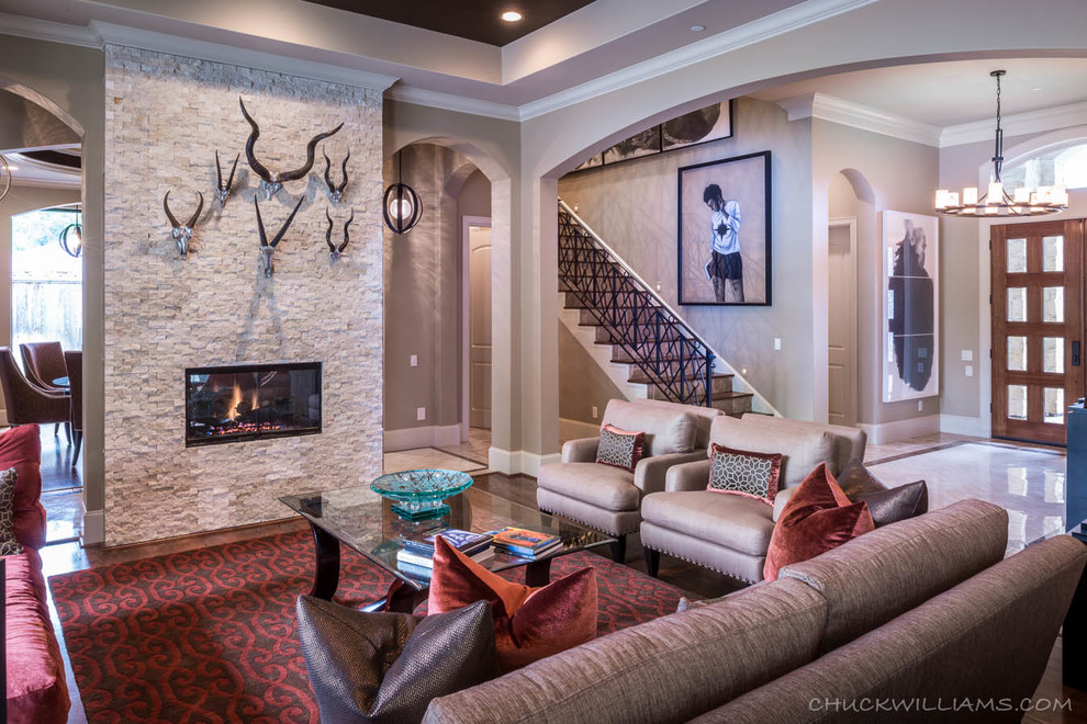 Large tuscan formal and open concept medium tone wood floor living room photo in Houston with beige walls, a two-sided fireplace, a stone fireplace and no tv