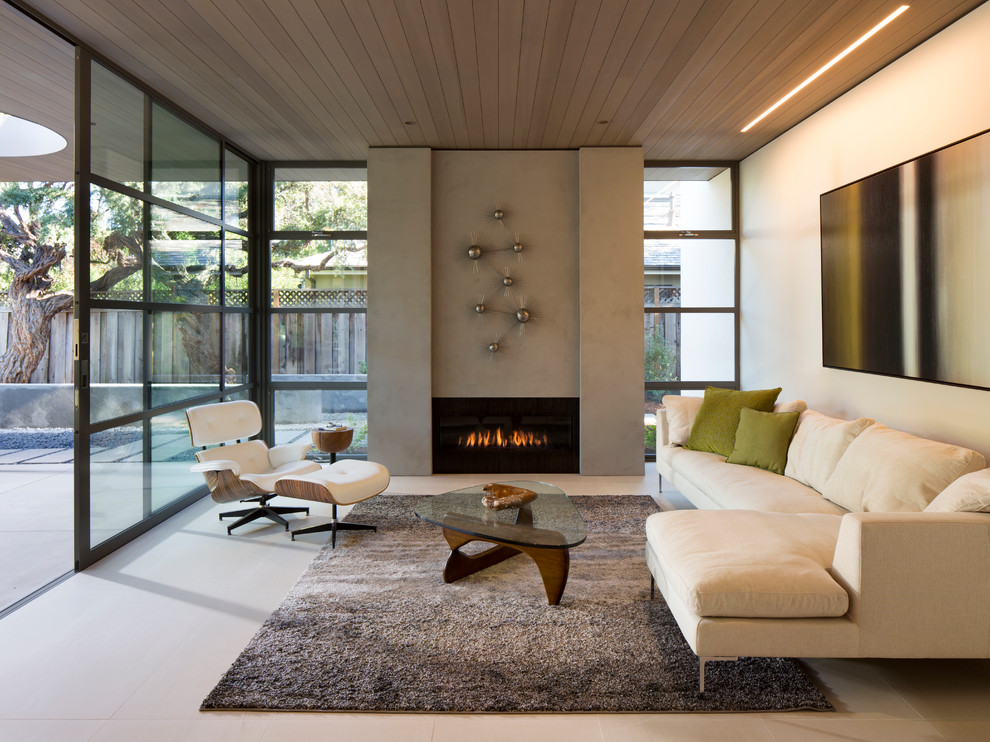 Идея дизайна: парадная, открытая гостиная комната среднего размера в стиле модернизм с стандартным камином и фасадом камина из бетона без телевизора