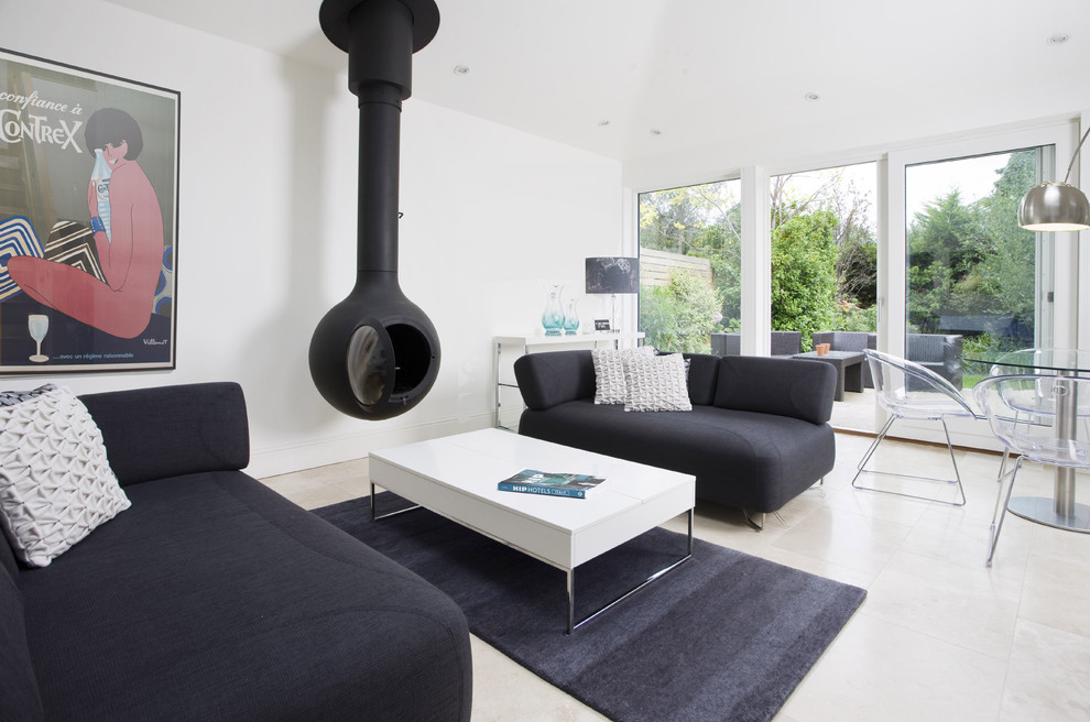 This is an example of a modern living room in Dublin with a hanging fireplace and a metal fireplace surround.