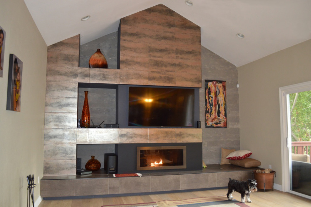Example of a mid-sized trendy formal and enclosed light wood floor and beige floor living room design in San Francisco with beige walls, a standard fireplace, a metal fireplace and a wall-mounted tv