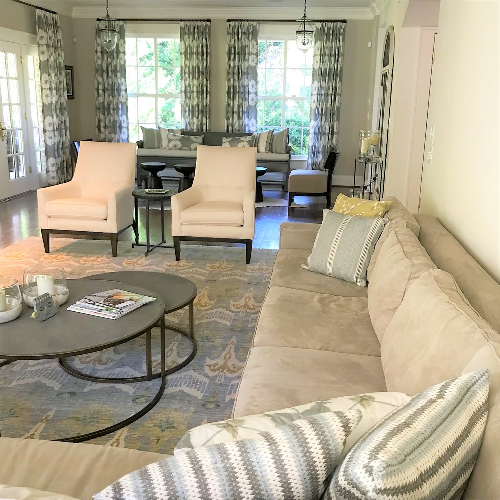 Immagine di un grande soggiorno eclettico aperto con pareti beige, pavimento in legno massello medio, camino classico, TV a parete e pavimento marrone