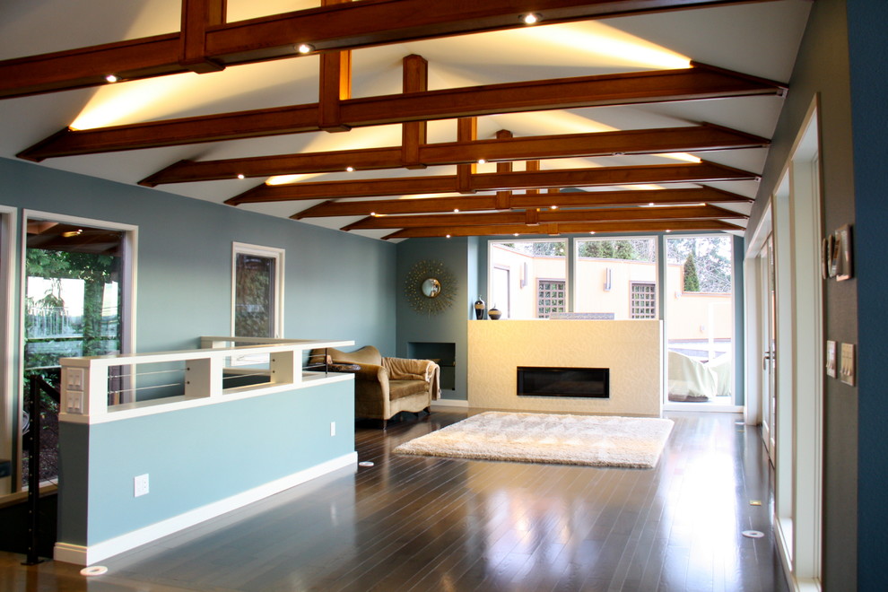 Inspiration for an expansive contemporary open plan living room in Seattle with blue walls, medium hardwood flooring, a standard fireplace, a tiled fireplace surround and brown floors.