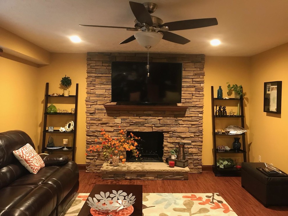 Photo of a medium sized classic formal enclosed living room in Other with beige walls, dark hardwood flooring, a standard fireplace, a stone fireplace surround, a wall mounted tv and brown floors.