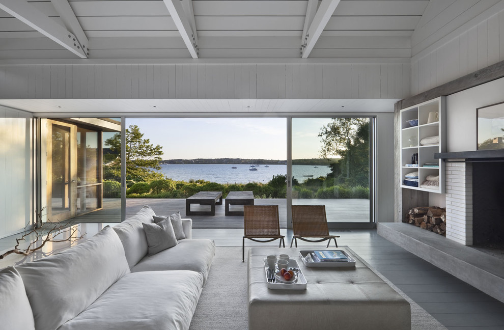 Inspiration for a coastal living room remodel in New York with a standard fireplace and a brick fireplace