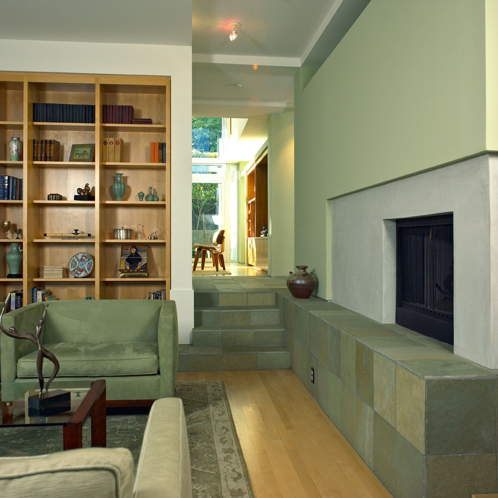 На фото: гостиная комната в стиле модернизм с фасадом камина из бетона с