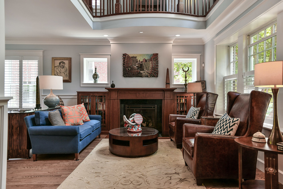 Design ideas for a classic formal enclosed living room in Other with blue walls, medium hardwood flooring, a standard fireplace, a wooden fireplace surround, no tv and brown floors.