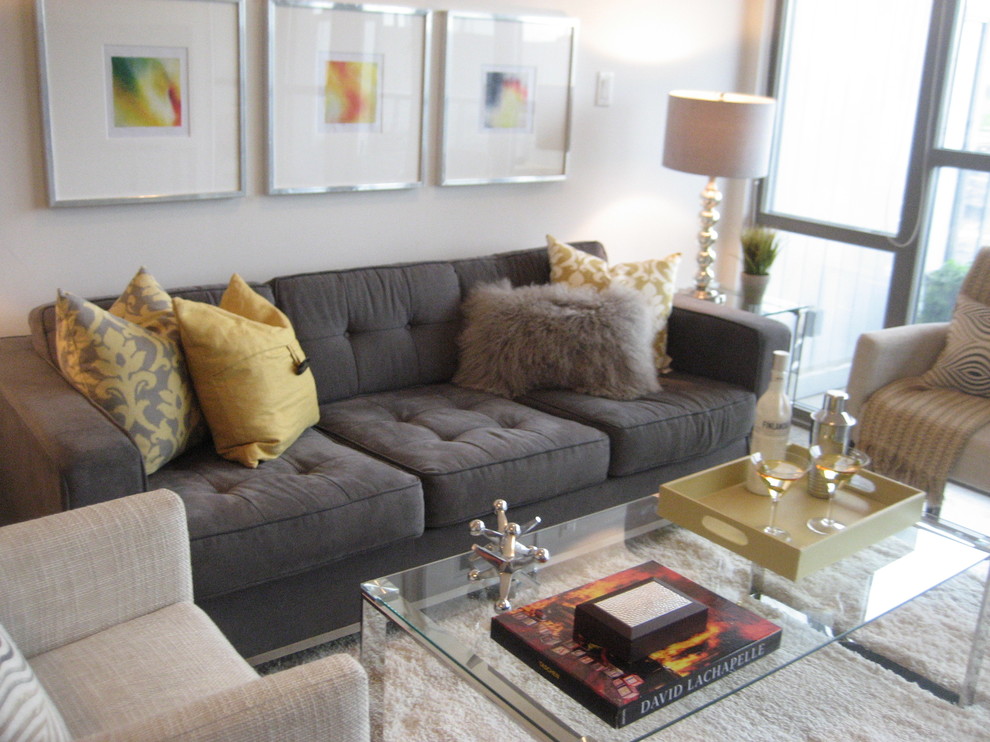 Example of a small trendy open concept and formal concrete floor and gray floor living room design in Toronto with gray walls, a tv stand and no fireplace