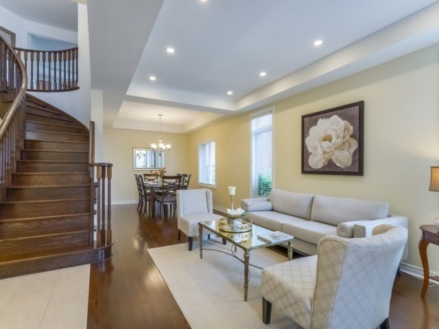 This is an example of a medium sized traditional formal open plan living room in Toronto with yellow walls, dark hardwood flooring, no fireplace, no tv and brown floors.