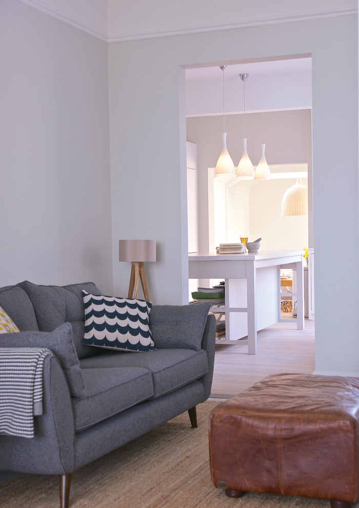 Esempio di un soggiorno stile marino di medie dimensioni e aperto con pareti grigie, pavimento in legno verniciato, soffitto a cassettoni e pannellatura
