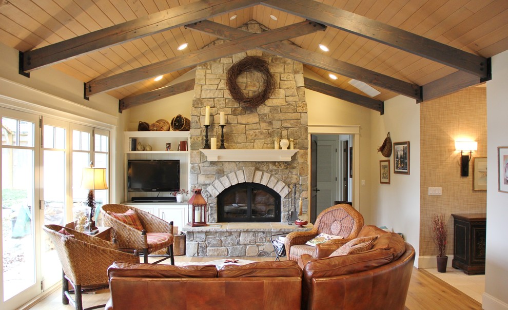 Inspiration for a mid-sized timeless open concept medium tone wood floor living room remodel in Seattle with beige walls, a standard fireplace, a stone fireplace and a media wall