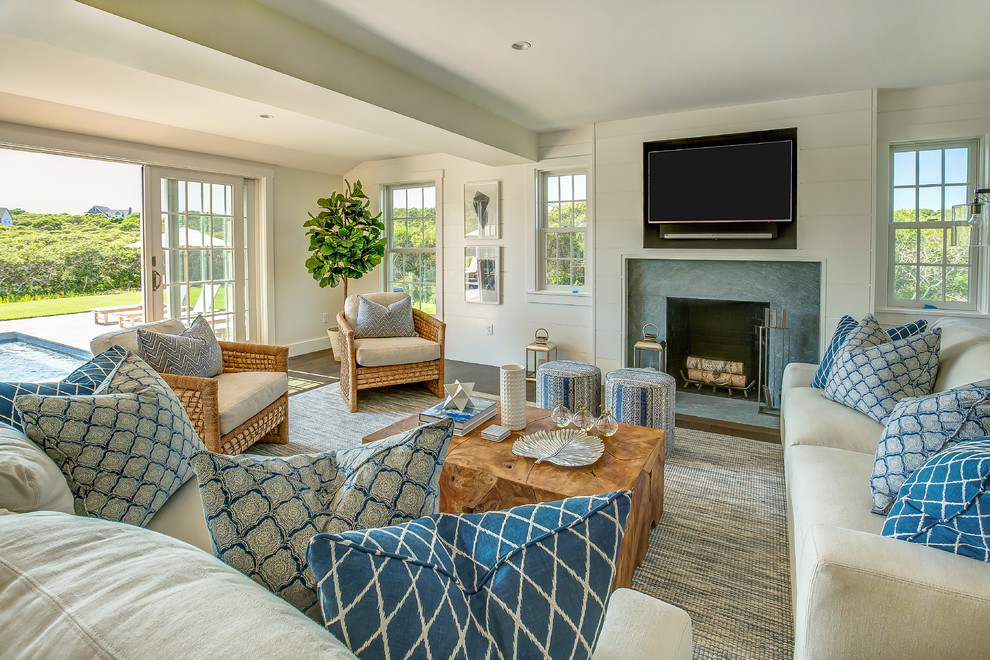 Medium sized beach style open plan living room in Other with white walls, medium hardwood flooring, a standard fireplace, a stone fireplace surround, no tv and brown floors.