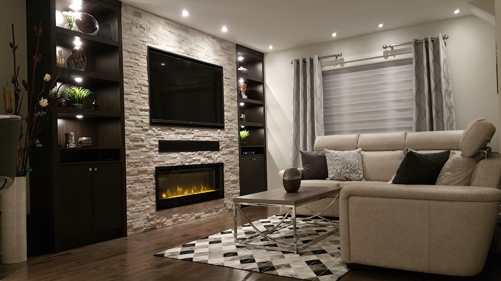 Example of a large trendy formal and open concept dark wood floor living room design in Montreal with white walls, a standard fireplace, a stone fireplace and a wall-mounted tv