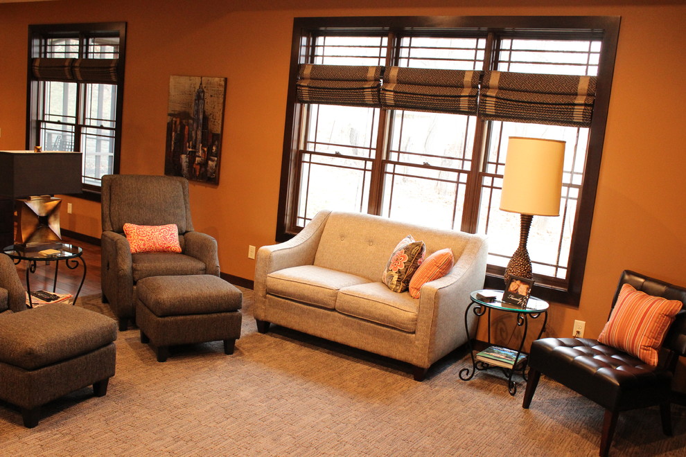 Photo of a medium sized modern enclosed living room in Other with brown walls, carpet and brown floors.