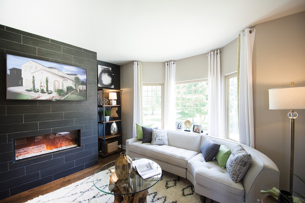 Elegant living room photo in Chicago with beige walls, a standard fireplace, a tile fireplace and a wall-mounted tv