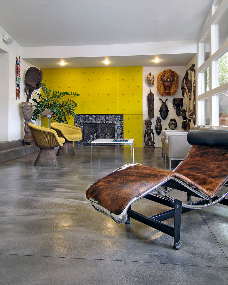Example of an eclectic concrete floor living room design in Portland with a standard fireplace and a tile fireplace