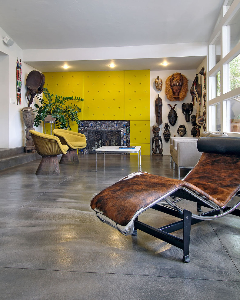 Bohemian living room feature wall in Portland with concrete flooring, a standard fireplace and a tiled fireplace surround.