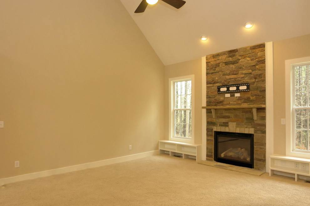 Medium sized traditional open plan living room in Raleigh with beige walls, carpet, a standard fireplace, a stone fireplace surround and a built-in media unit.
