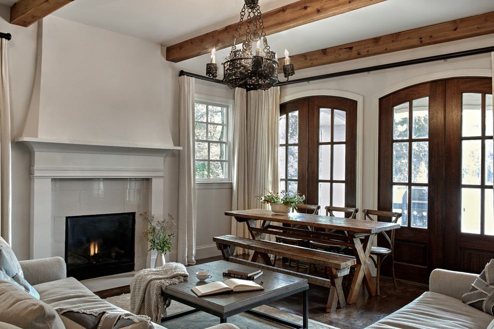 Inspiration for a large mediterranean open concept medium tone wood floor living room remodel in Nashville with a standard fireplace and a wood fireplace surround