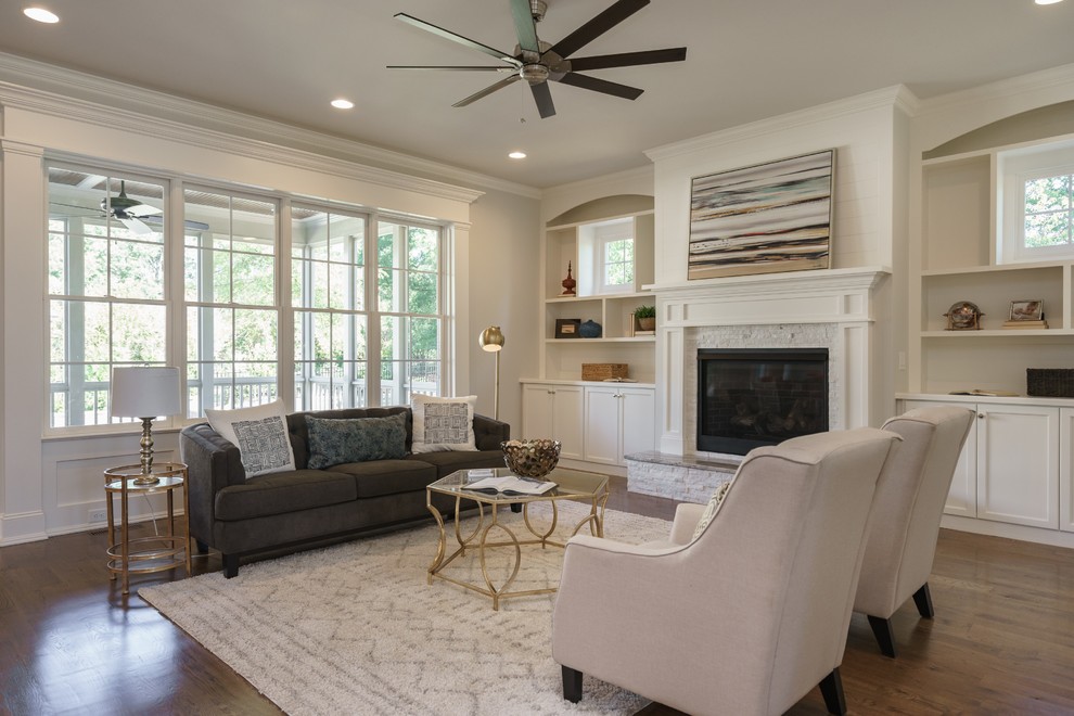 Inspiration for a transitional medium tone wood floor living room remodel in Raleigh with gray walls, a standard fireplace and a tile fireplace